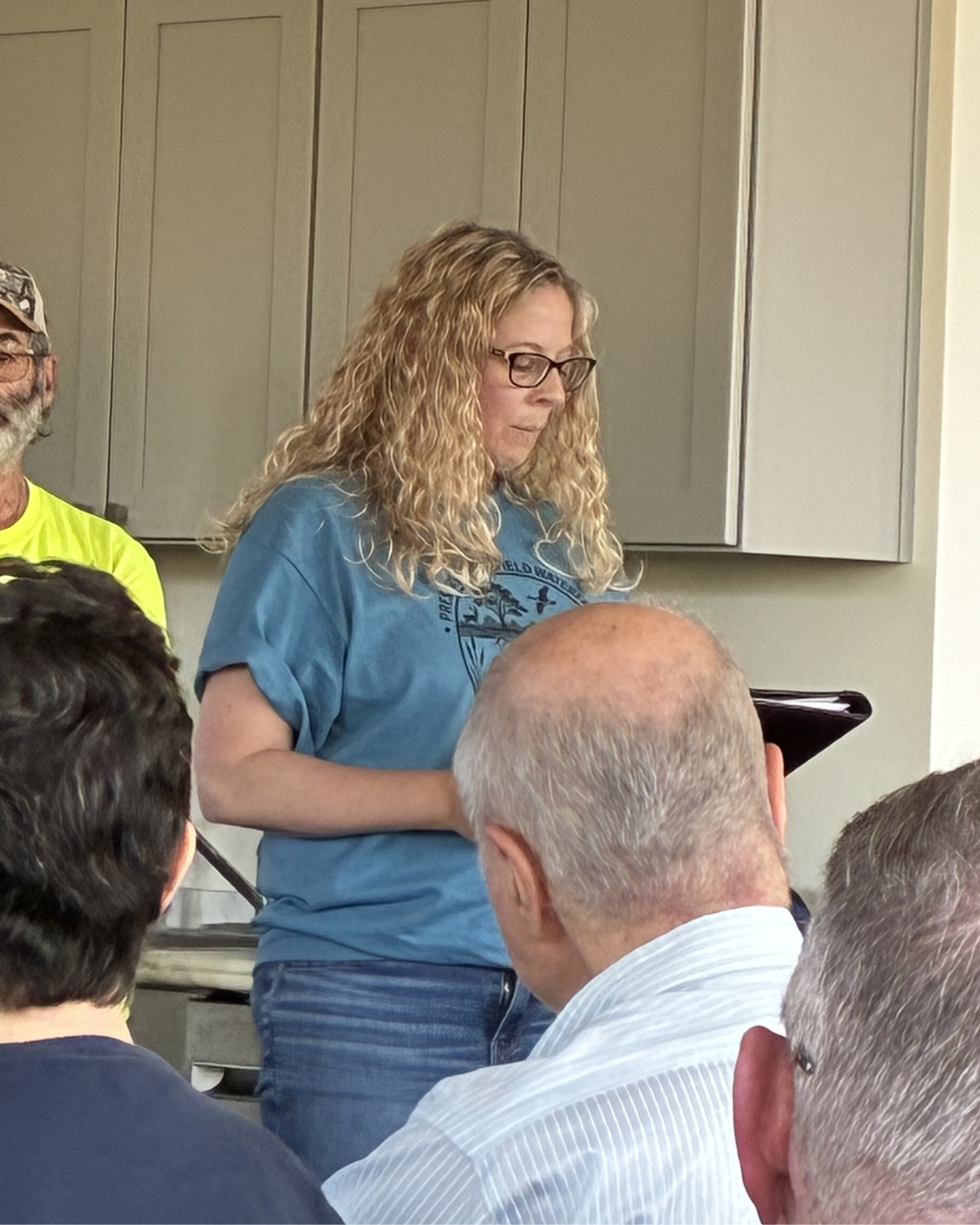 A resident reading a prepared statement at the microphone
