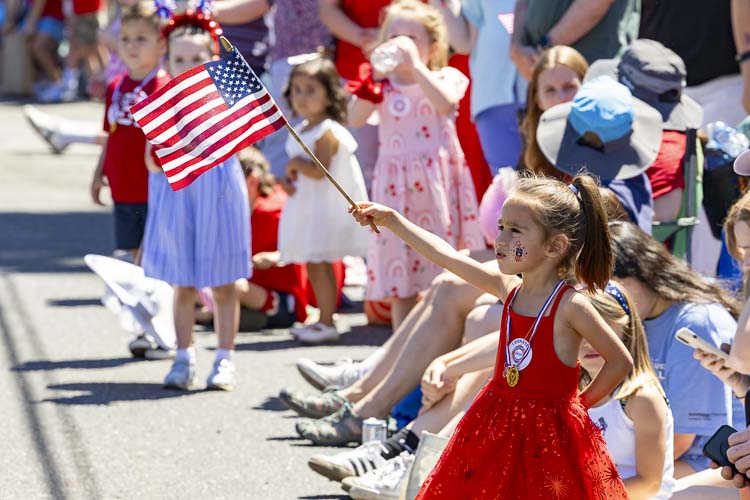 Little girl waving an American flag at the Ridgefield 4th of July parade