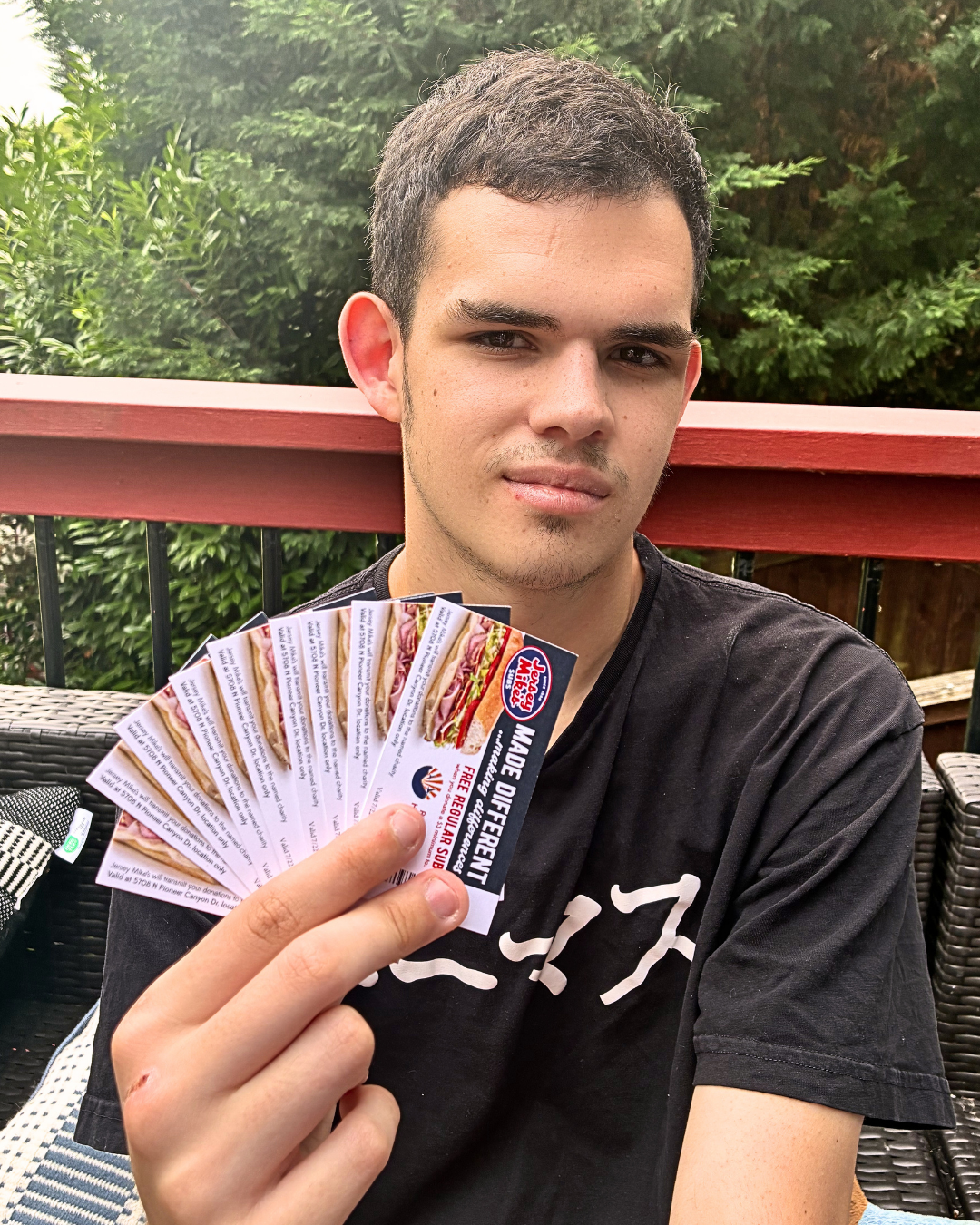 Shannon's son holding Jersey Mike's grand opening coupons in Ridgefield