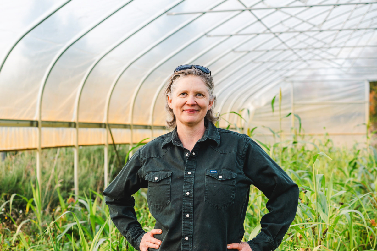April Thatcher standing in the greenhouse at April Joy Farm near Ridgefield