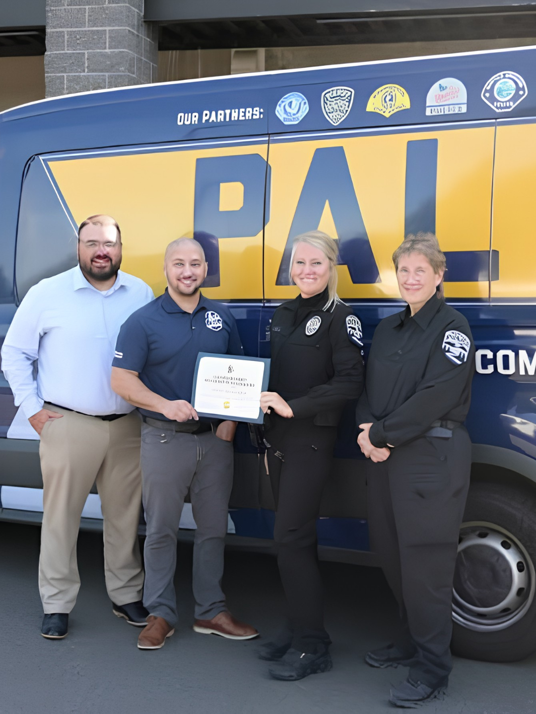 Ridgefield police officer Kaylin Debiak with the Police Activities League van after receiving her Law Enforcement Volunteer of the Quarter award