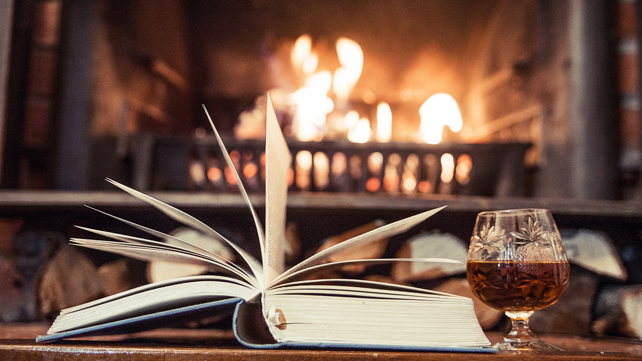 Books and a wine glass on a table at a Ridgefield reading night