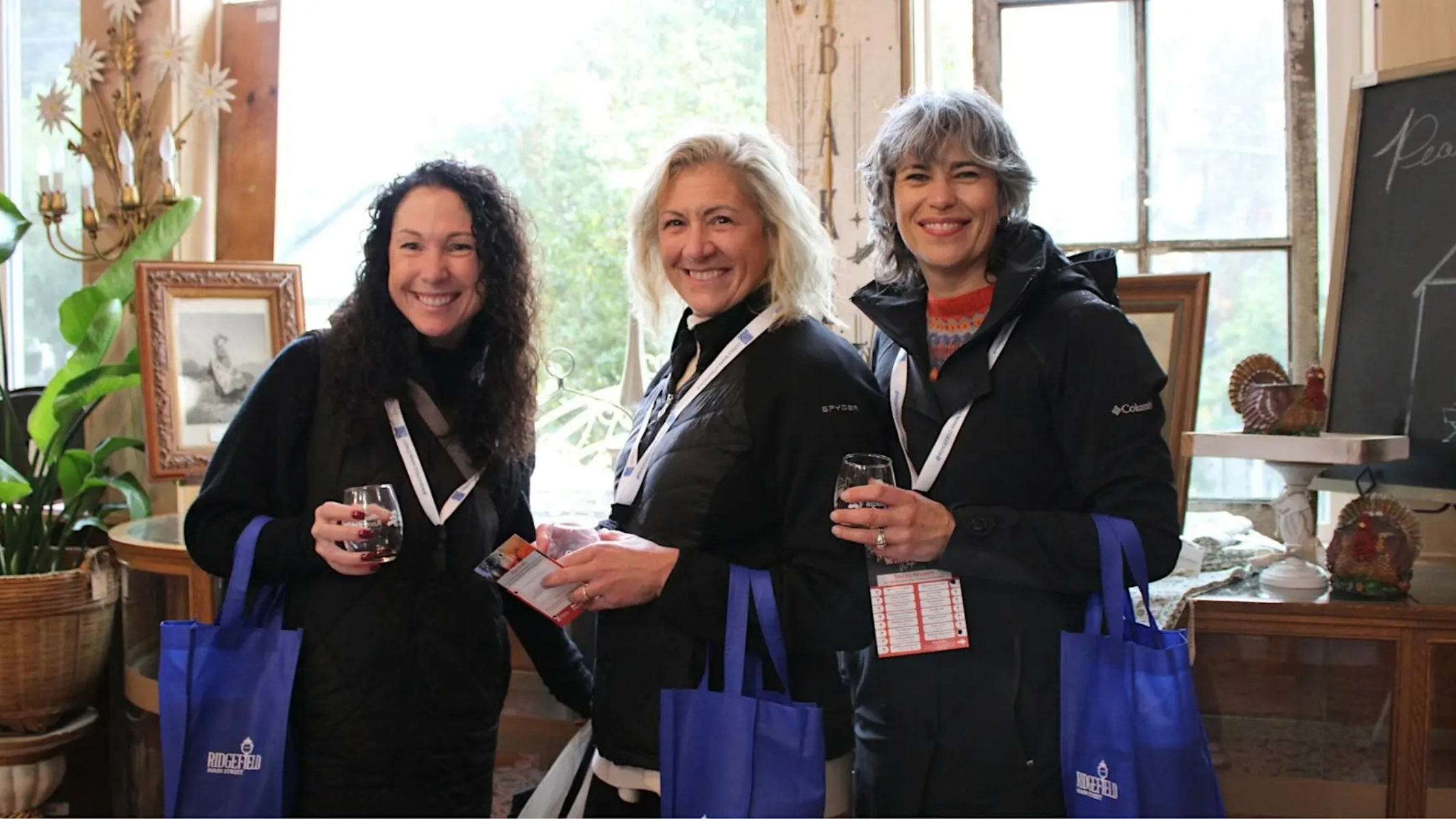 Friends holding wine glasses on Main Street in downtown Ridgefield